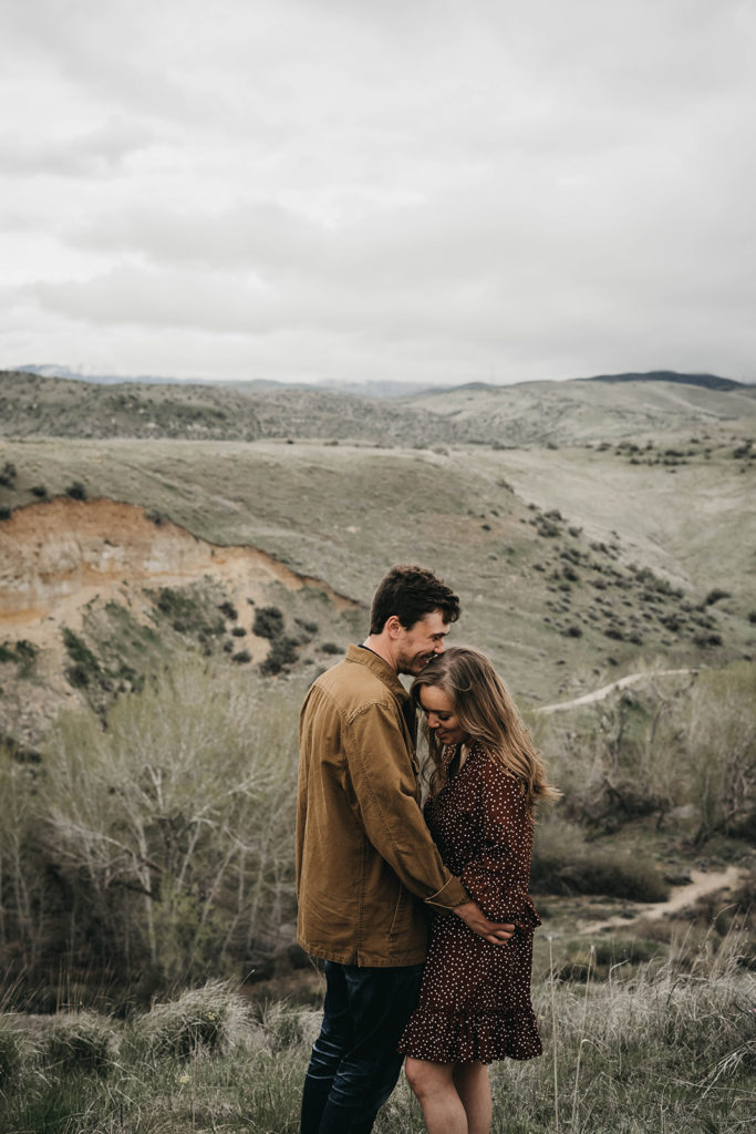 couple hugs each other in the boise foothills