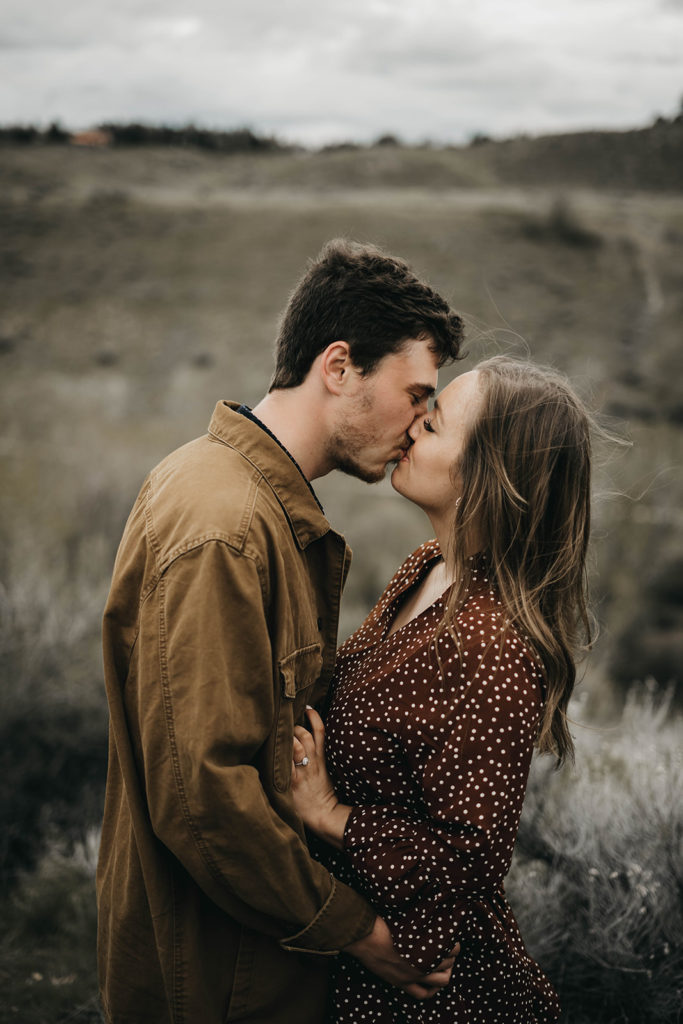 couple kisses during their boise foothills engagement session