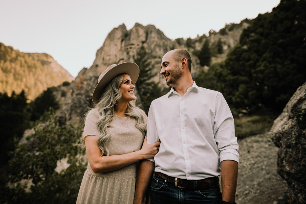 couple stands in front of rocky outcropping for their wolverine canyon engagement session