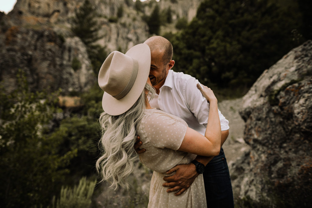 couple kisses in a rocky area in wolverine canyon for their engagement session