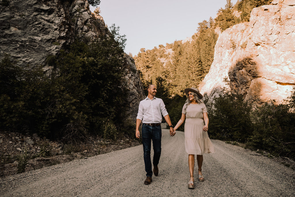 couple walking down the dirt road during their wolverine canyon engagement session