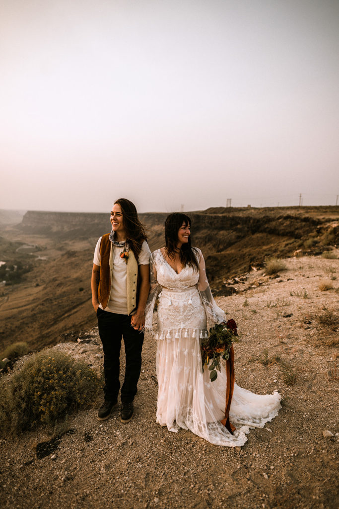 Portrait of two brides overlooking a canyon