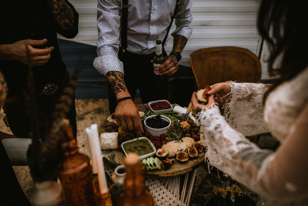 wedding guest and bride enjoy the reception with a charcuterie board