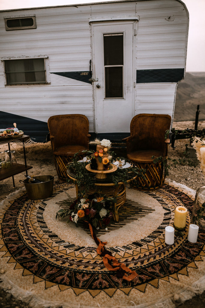 detail shot of the elopement reception decor set up in front of the vintage camper