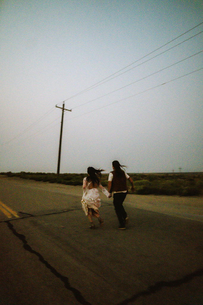 blurry photograph as newlywed couple runs away together at dusk