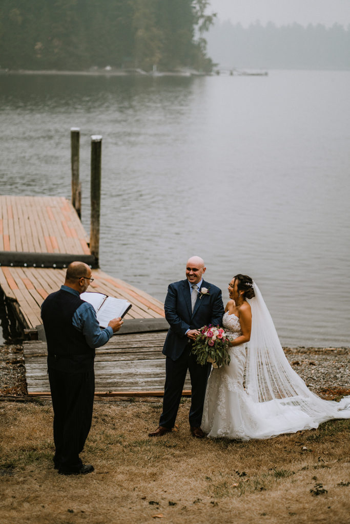 Bride and groom laughing on the beaches of a Tacoma Lake