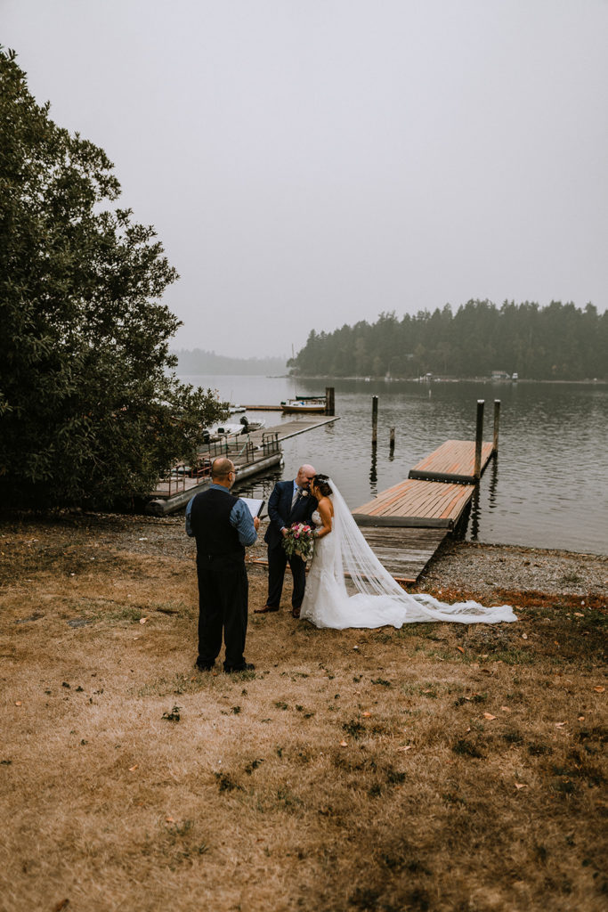 Groom whispers to his bride during the elopement ceremony
