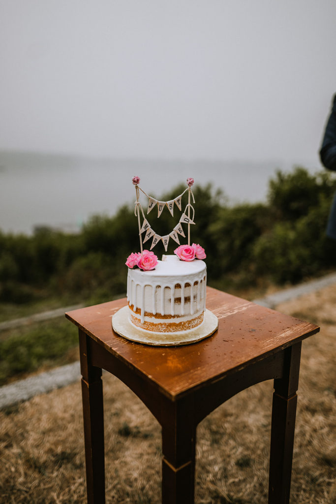 Detail shot of the wedding cake with the lake in the background