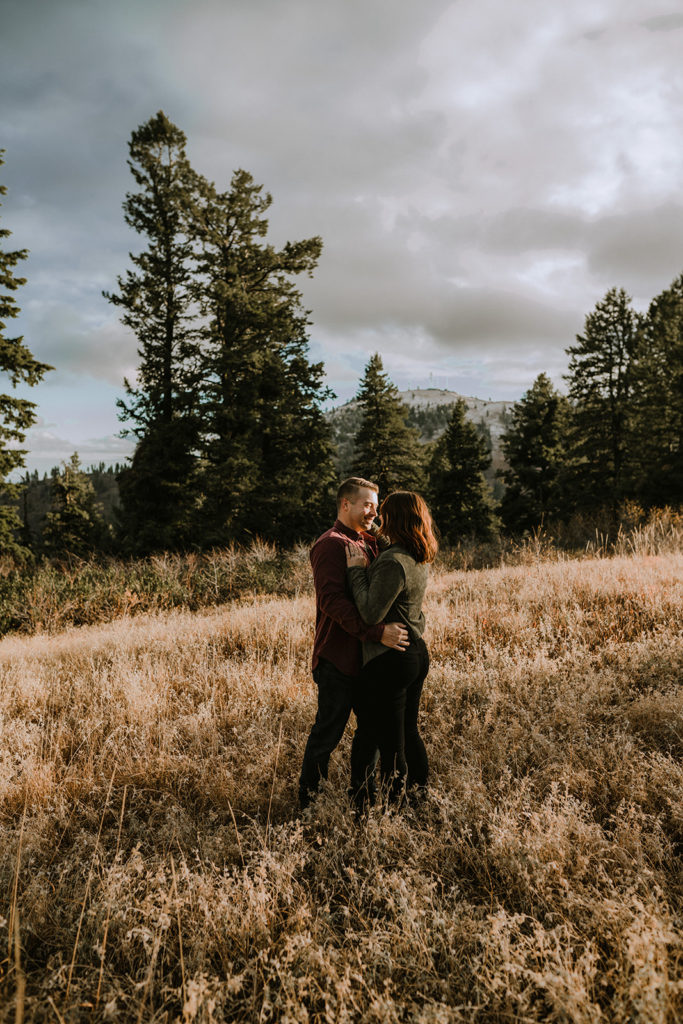 couple cuddles together during sunset in Bogus Basin