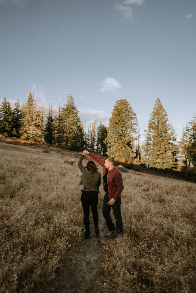 couple swing dances together on a trail near Bogus Basin