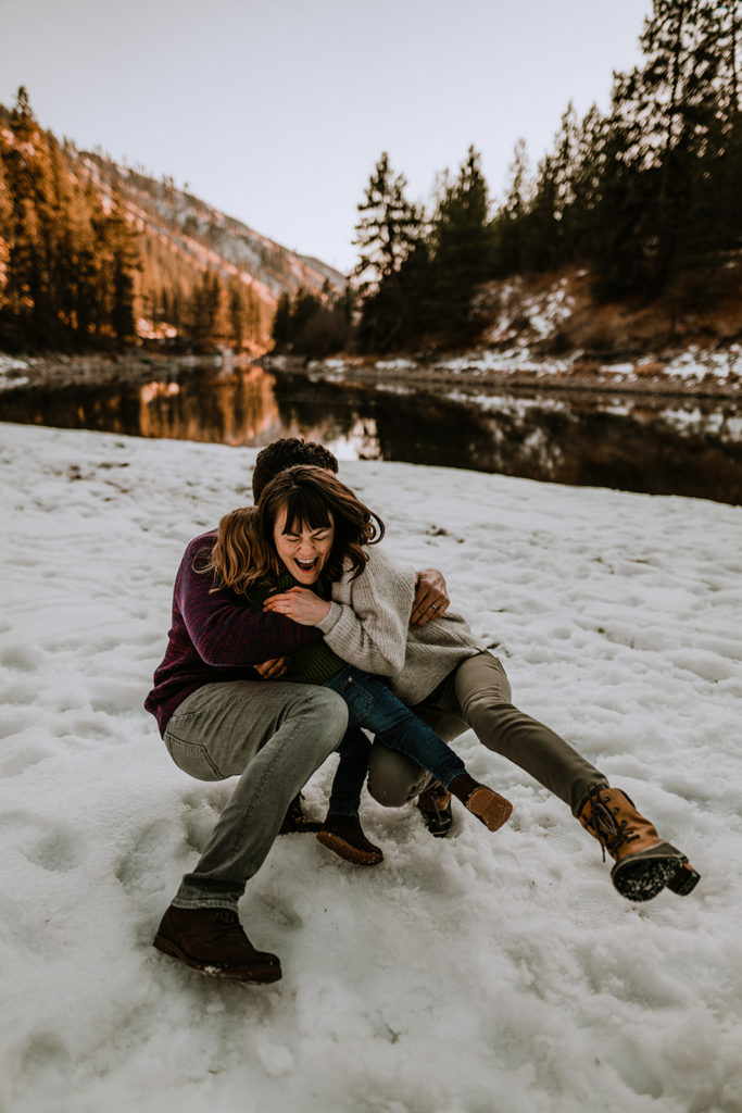 family getting knocked over into the snow during a Payette River family session