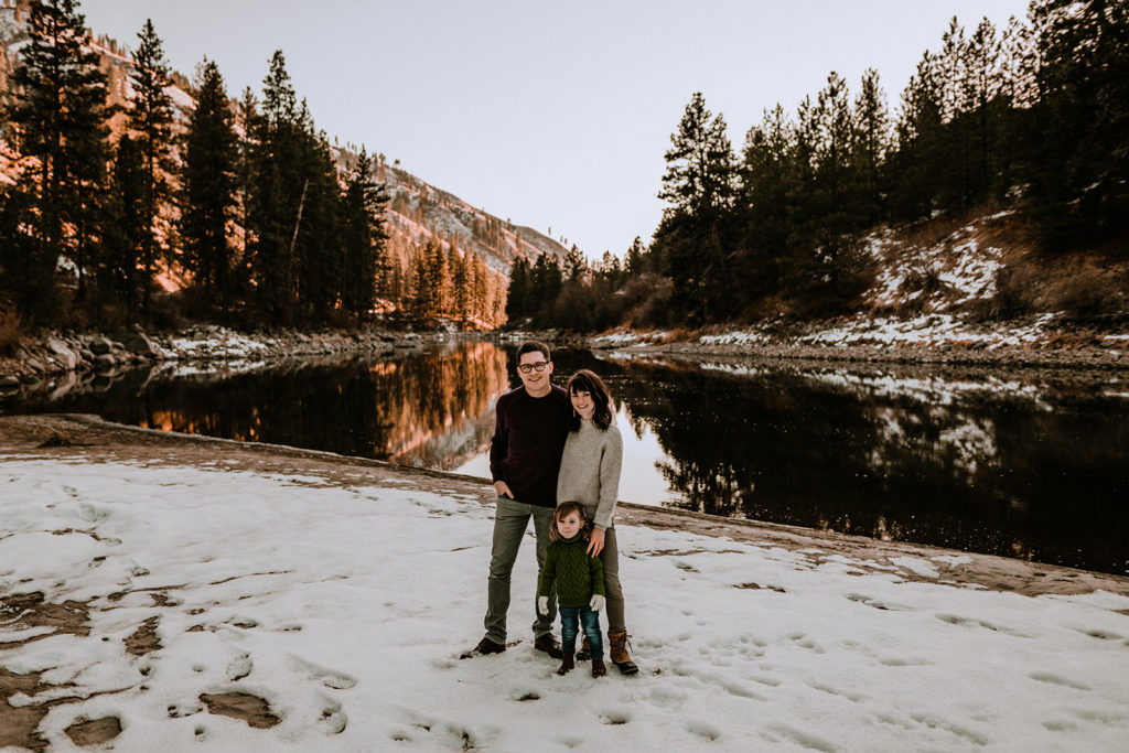 family poses on the banks of the Payette River