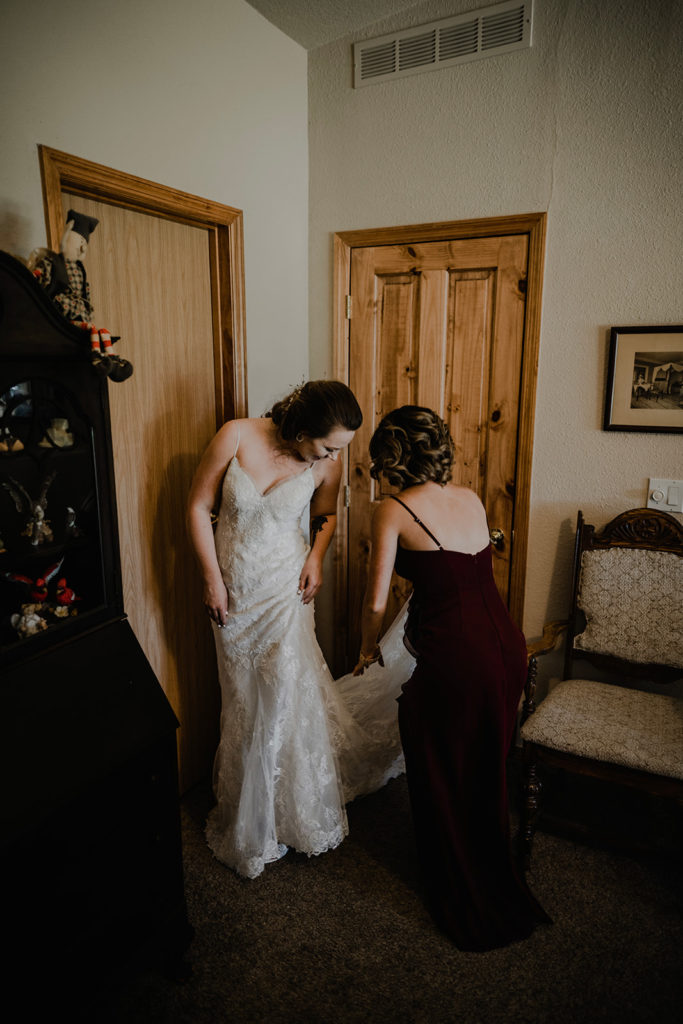bridesmaid fixes bride's wedding dress in the cabin in donnelly