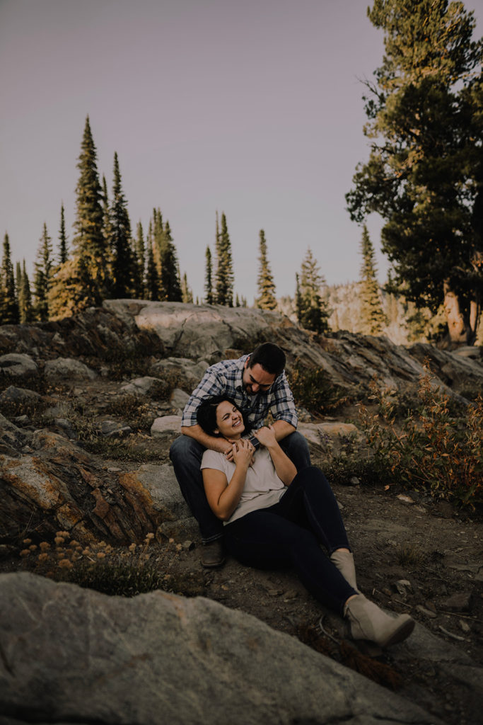 couple sitting on rock together during their Blue Lake engagement session