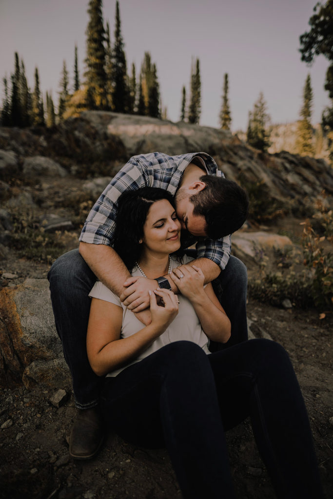 Couple embraces during their Blue Lake engagement session in Cascade