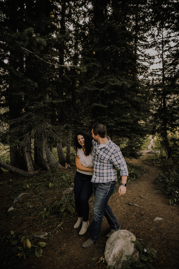 couple walks and laughs together on a hiking trail at Blue Lake in Cascade, Idaho