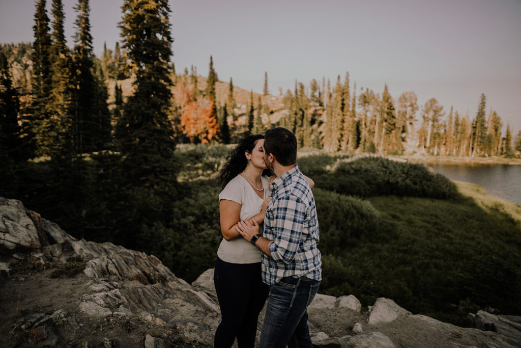 Couple kisses at Blue Lake for their engagement session in Cascade