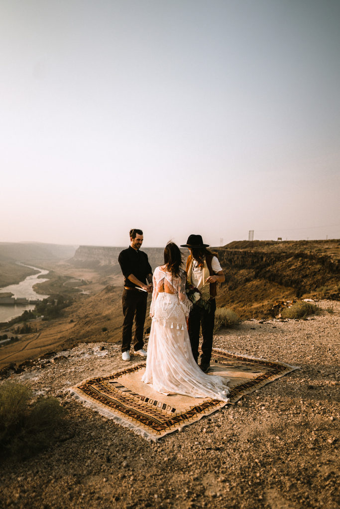 Bride's being married by their best friend overlooking the snake river canyon during their idaho elopement