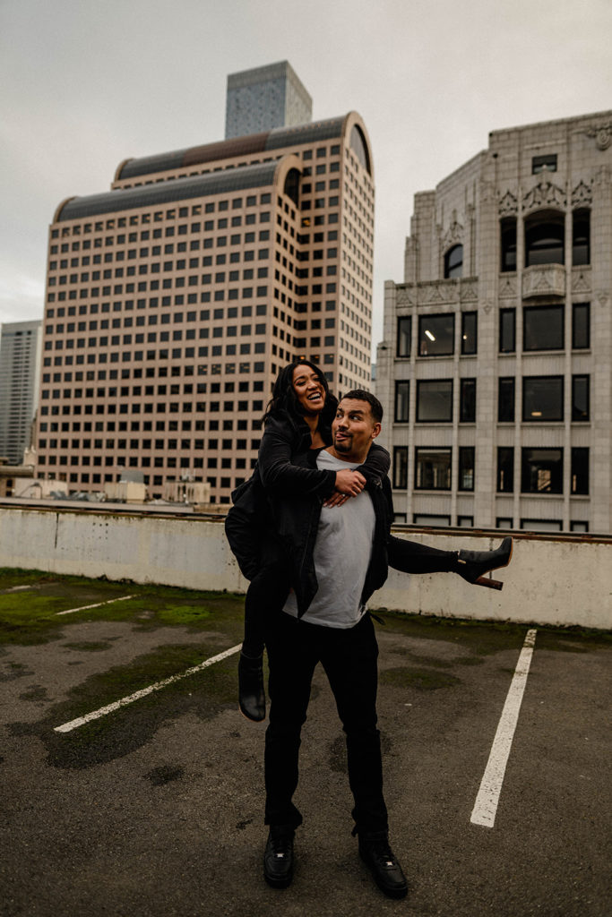 Goofing off with a piggyback ride on a rooftop in Downtown Seattle