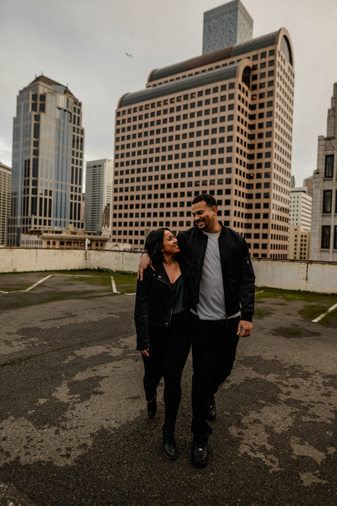 couple walking on a parking garage during their Seattle engagement session