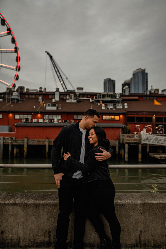 engagement session in front of The Great Wheel Seattle