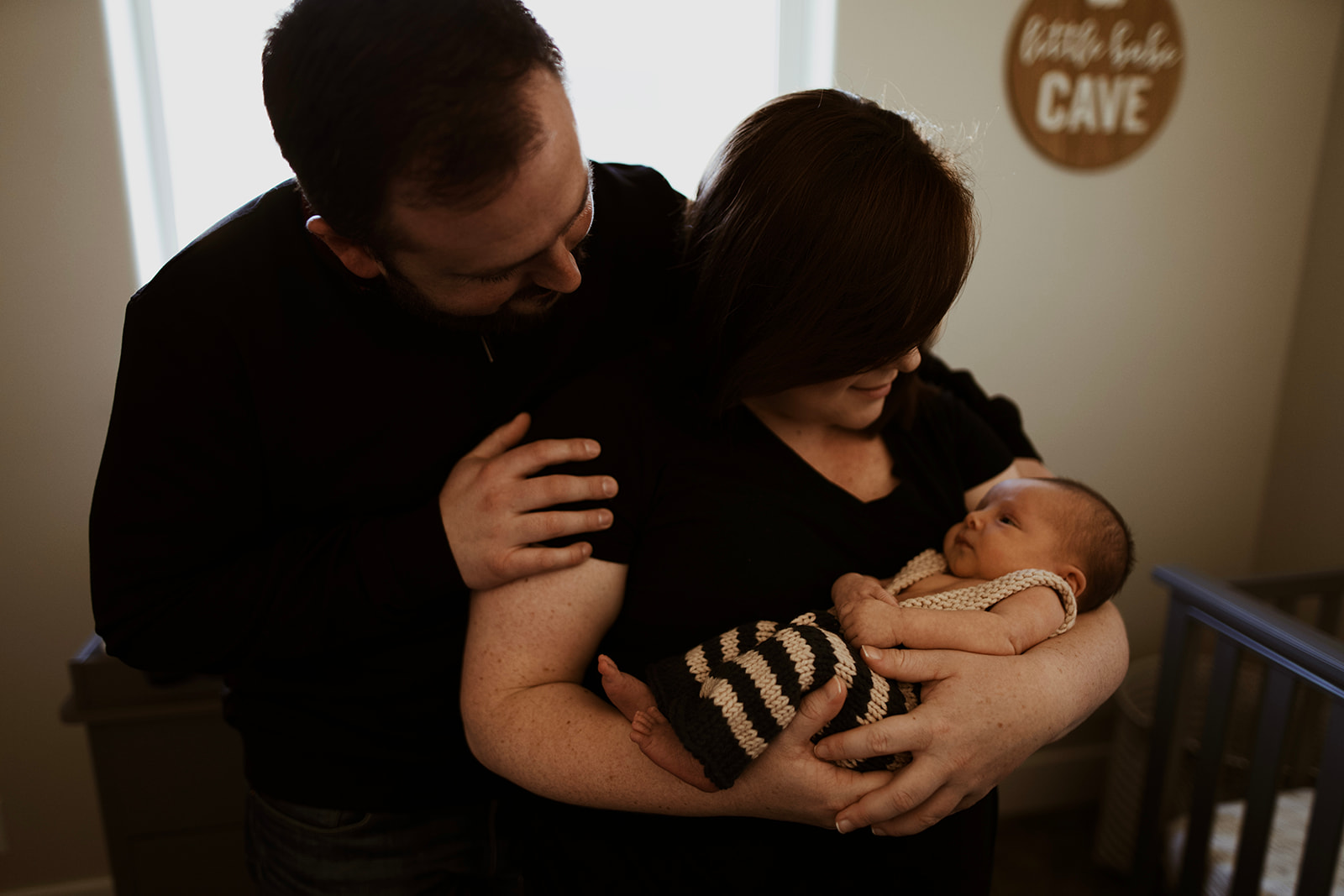 Parents holding their newborn son in his crochet outfit during their boise lifestyle newborn session