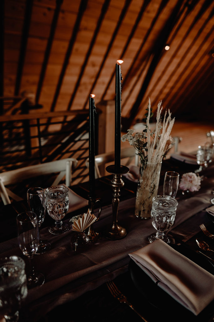 Romantic candlelit reception decor, black candles, gold candlesticks and elegant blush and black table decor