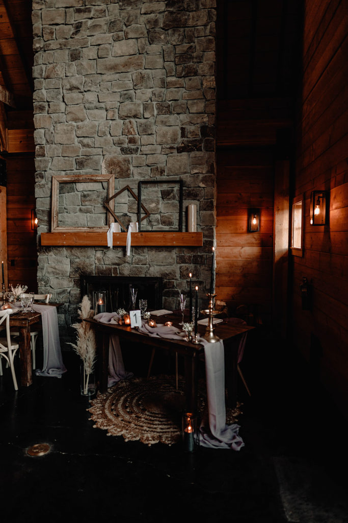 Photo of the sweethearts table inside the Foster Creek Farm barn with black and blush accent pieces