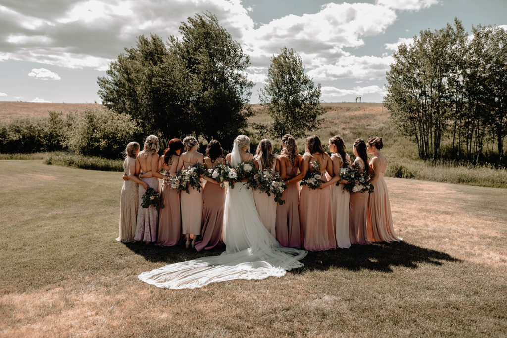 Large bridal party photo showing off their bouquets with the bride during the Foster Creek Farm wedding