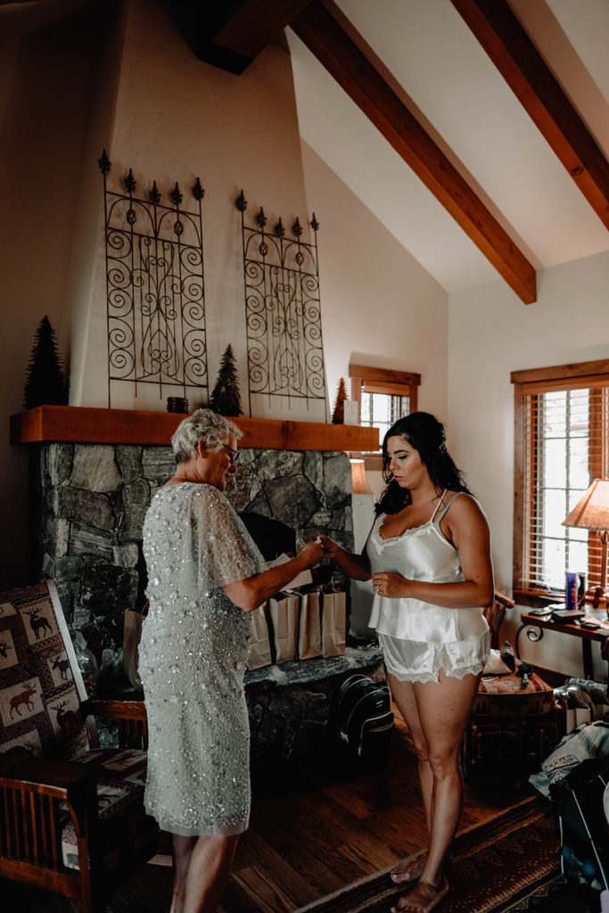 Bride gives a gift to her mother while she is getting ready for her Tamarack Resort wedding
