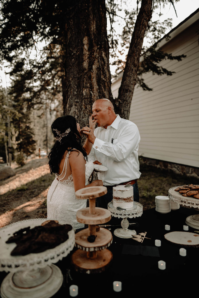 Newlyweds share and feed each other wedding cake after the cake cutting