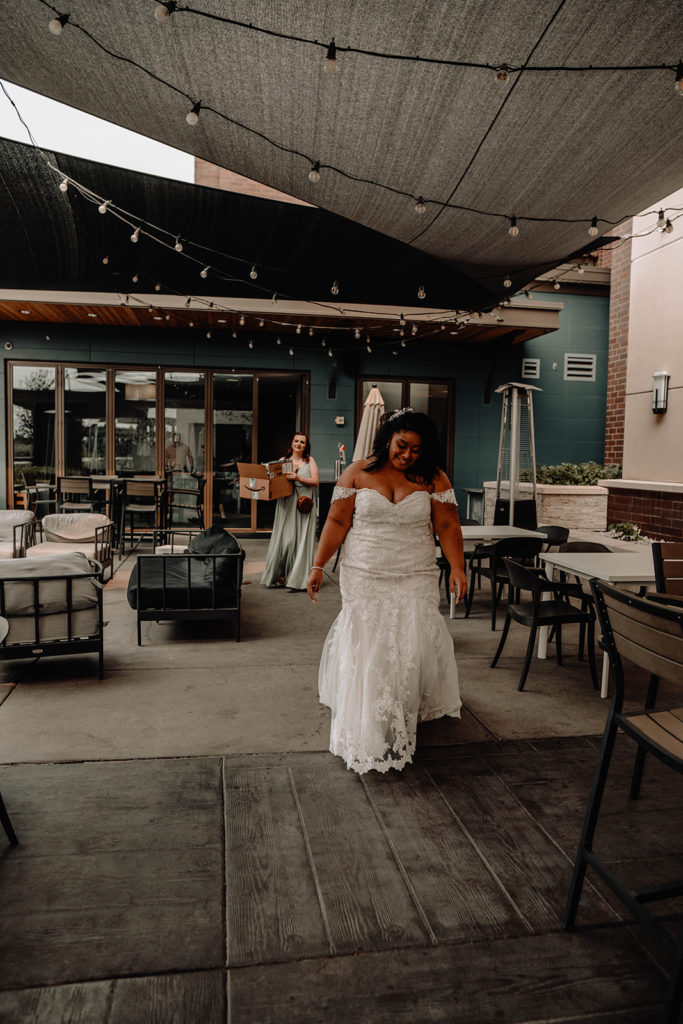 Bride begins walking towards the downtown Boise Residence Inn balcony to see her groom for their first look