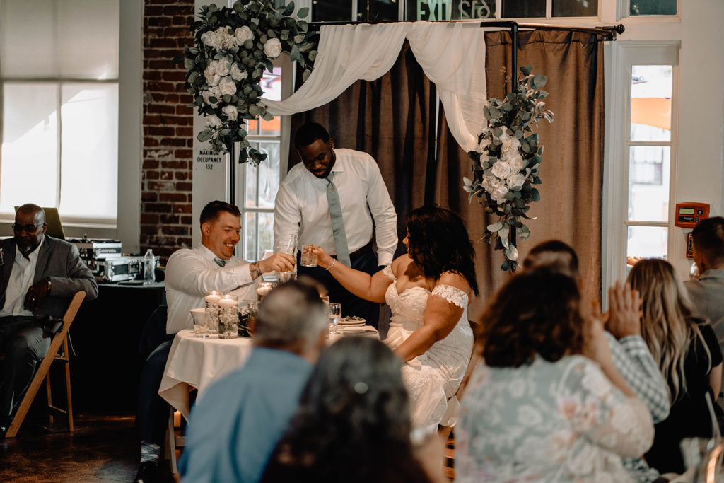 Bride and groom share a drink with the Best Man after he gave his speech