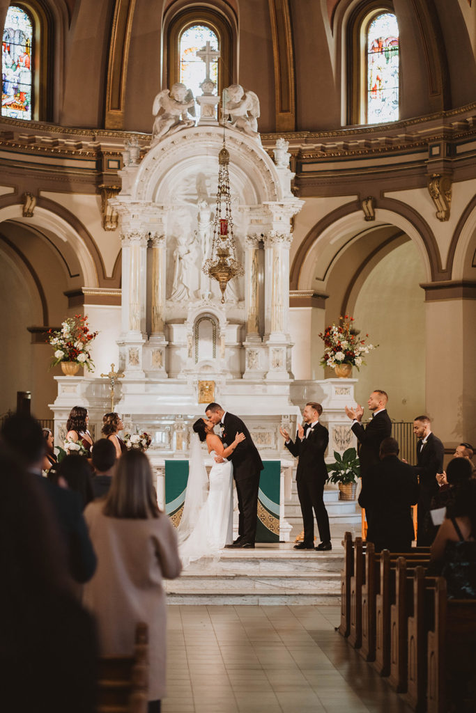 Bride and groom share their first kiss in the chapel at Gonzaga University