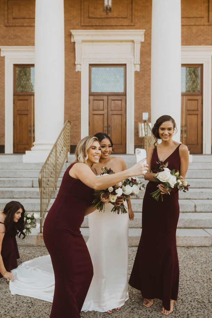 Bride and her bridesmaids arrive at the church and take photos together before the ceremony.