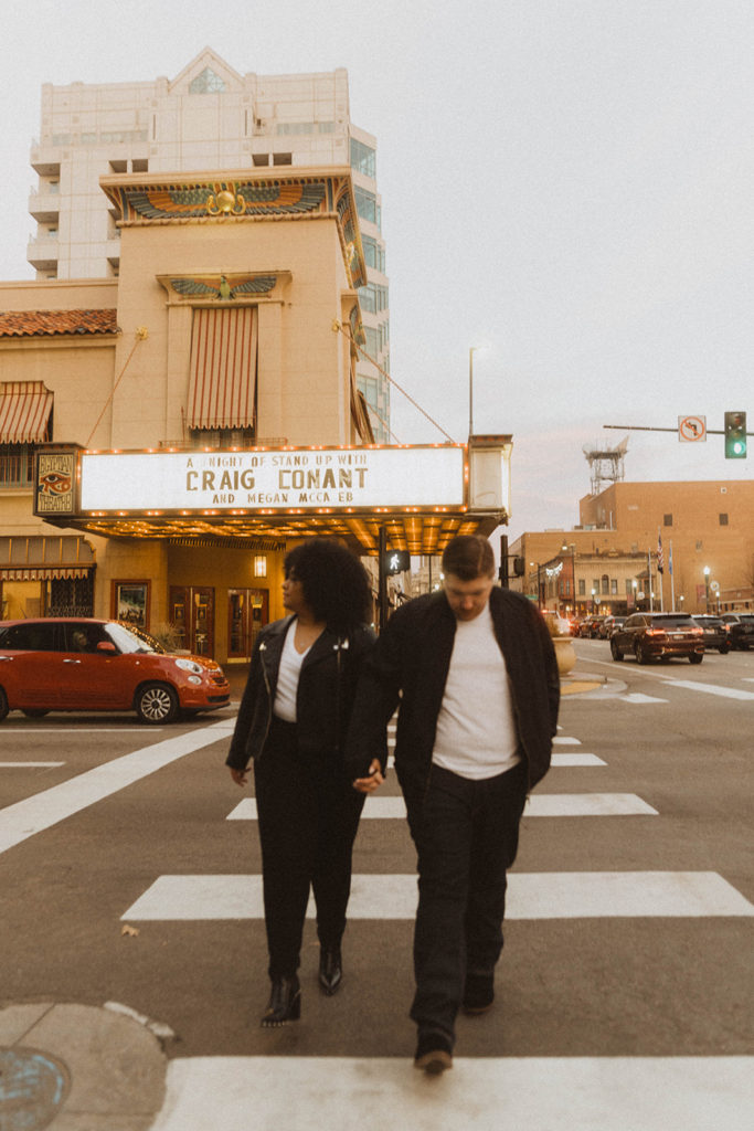 couple walks in front of the egyptian theater