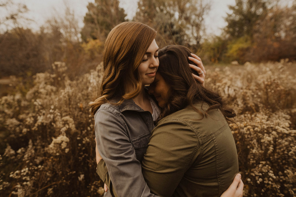 lgbtq couple cuddles up together during their Kathryn Albertson Park engagement session