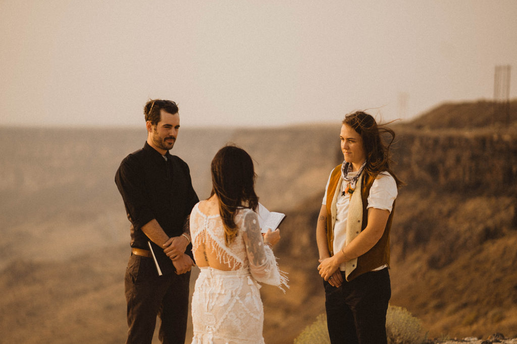 photo of a couple saying their vows on the rim of the snake river canyon with best reasons to elope below