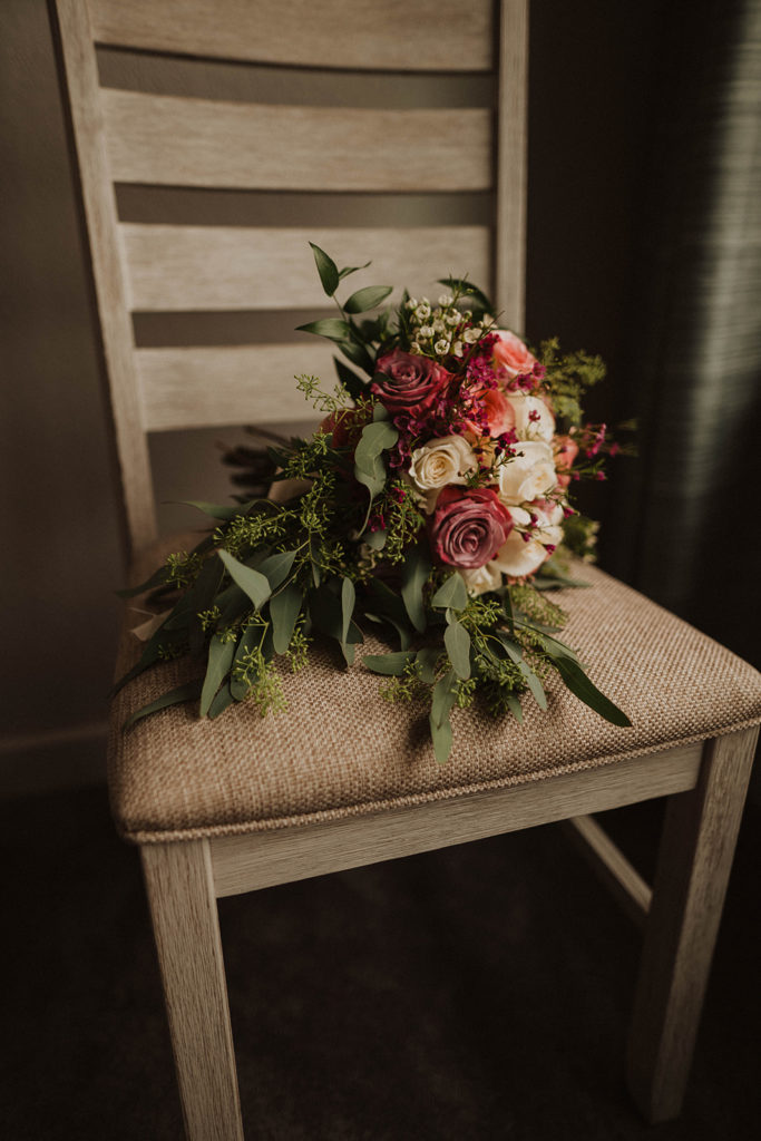 elopement floral bouquet rests on a chair during a lakeside tacoma elopement
