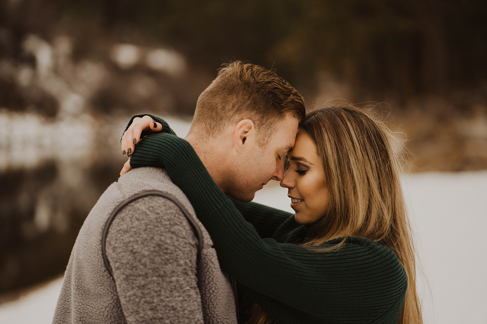 couple cuddles together in the Idaho snowy mountains during their payette river couple session
