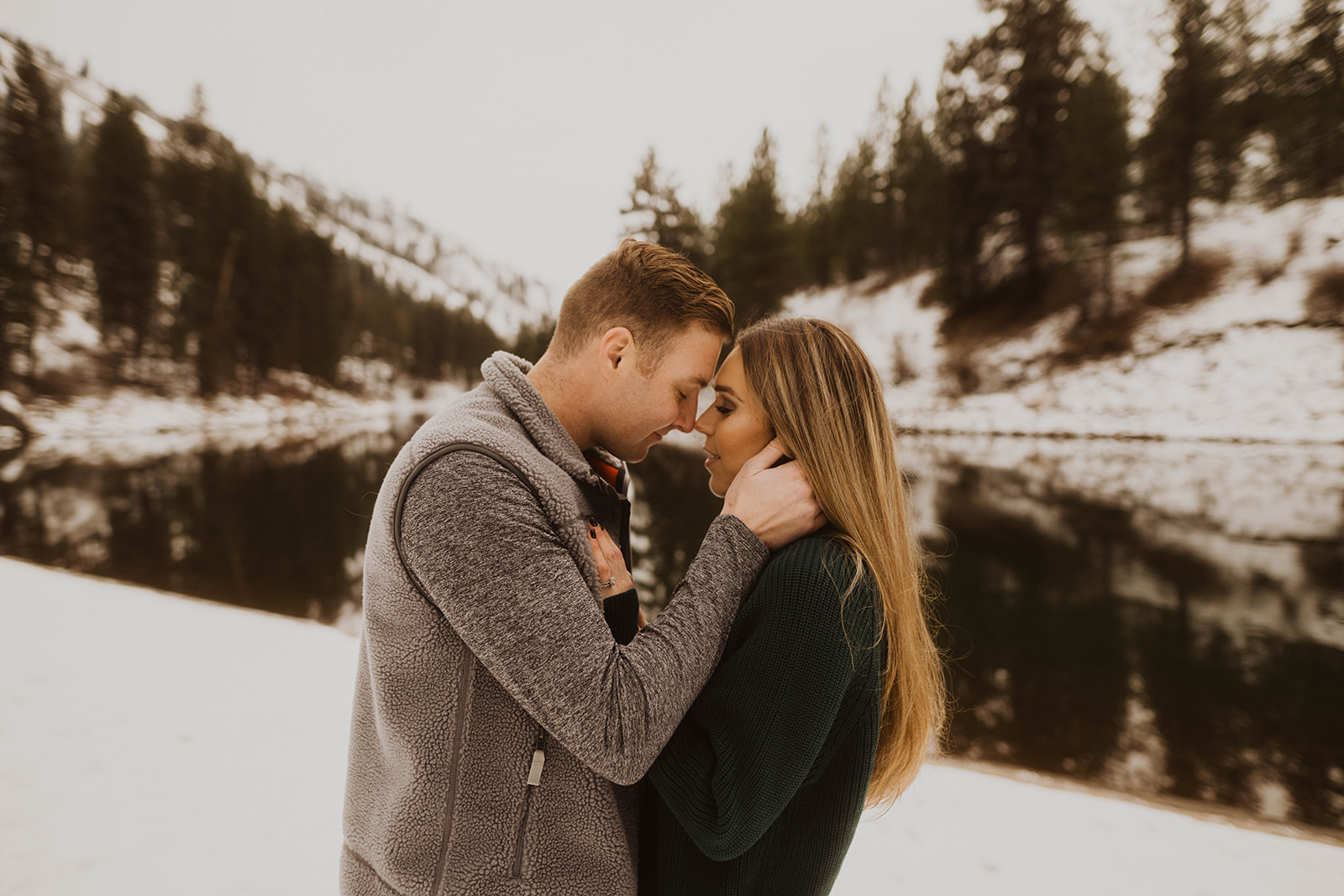 couple stands in front of the payette river during their couple session