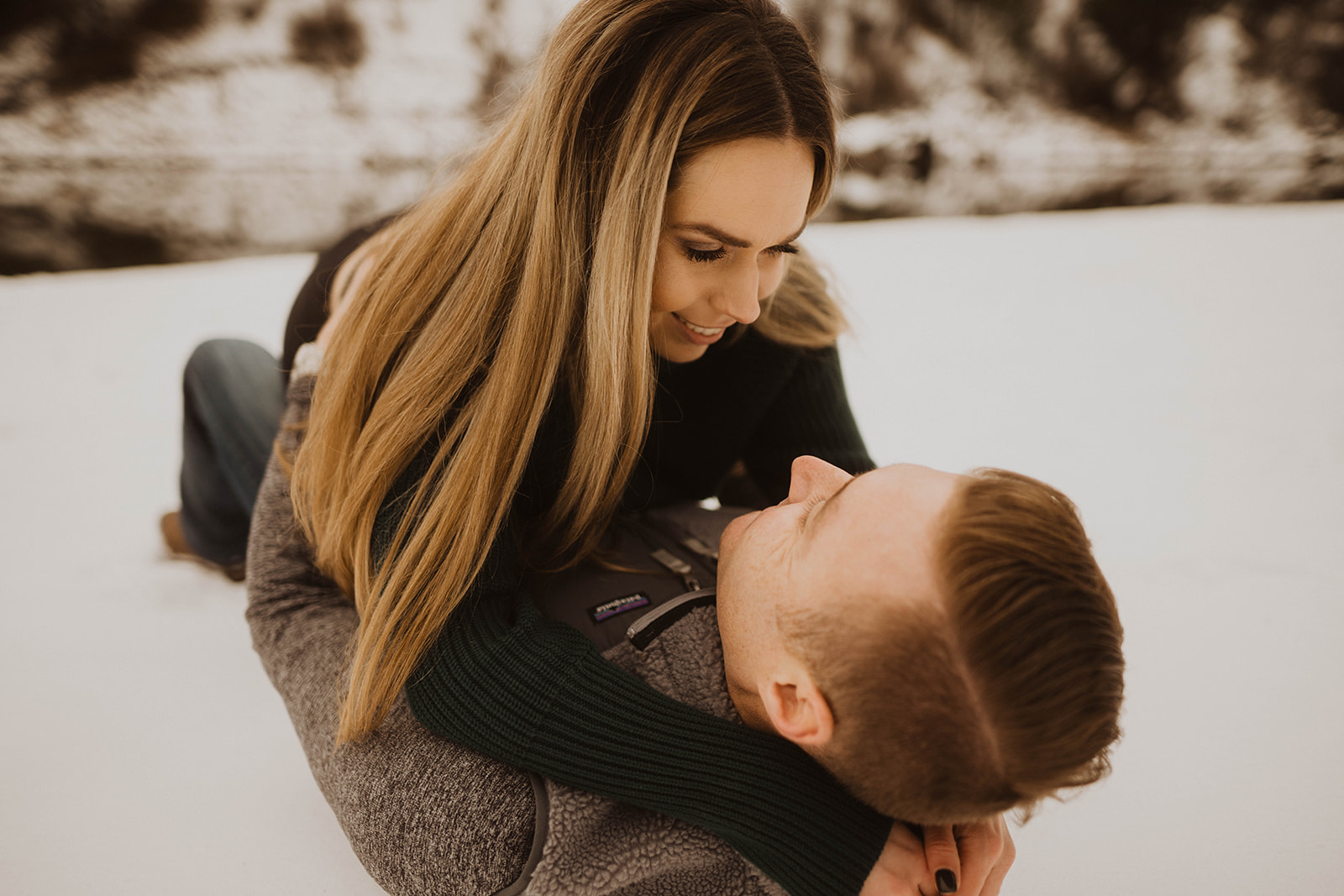 couple plays in the snow during their banks beach payette river couple session