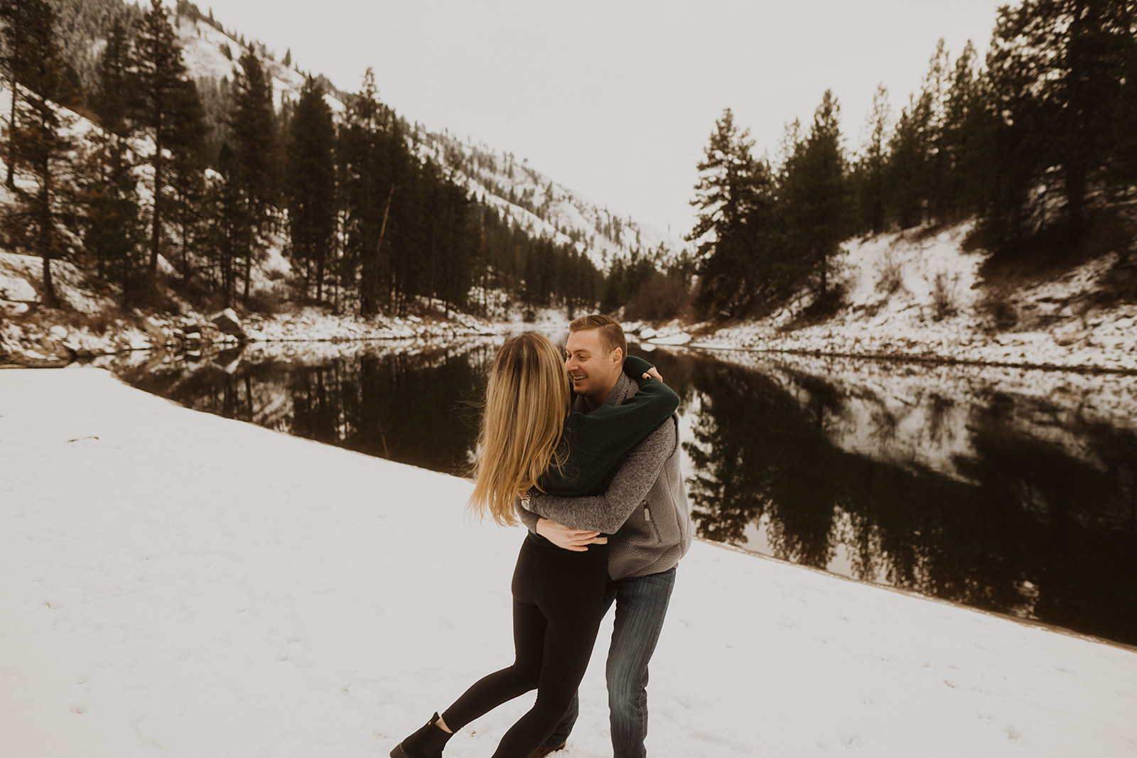 couple spins in the snow during their payette river couple session
