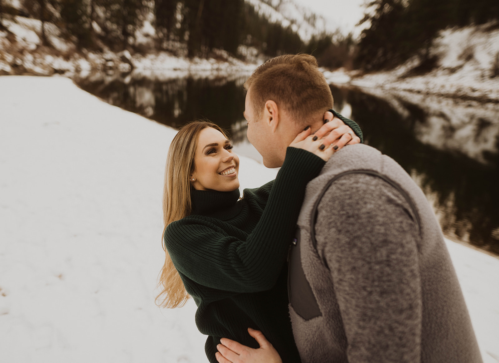 couple laughs together during their payette river couple session