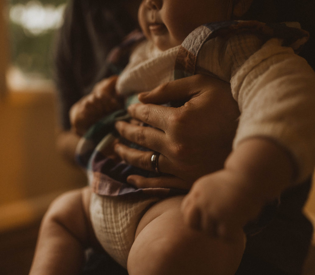 close up photo of baby Sora and her dad's hands during their seattle family lifestyle session