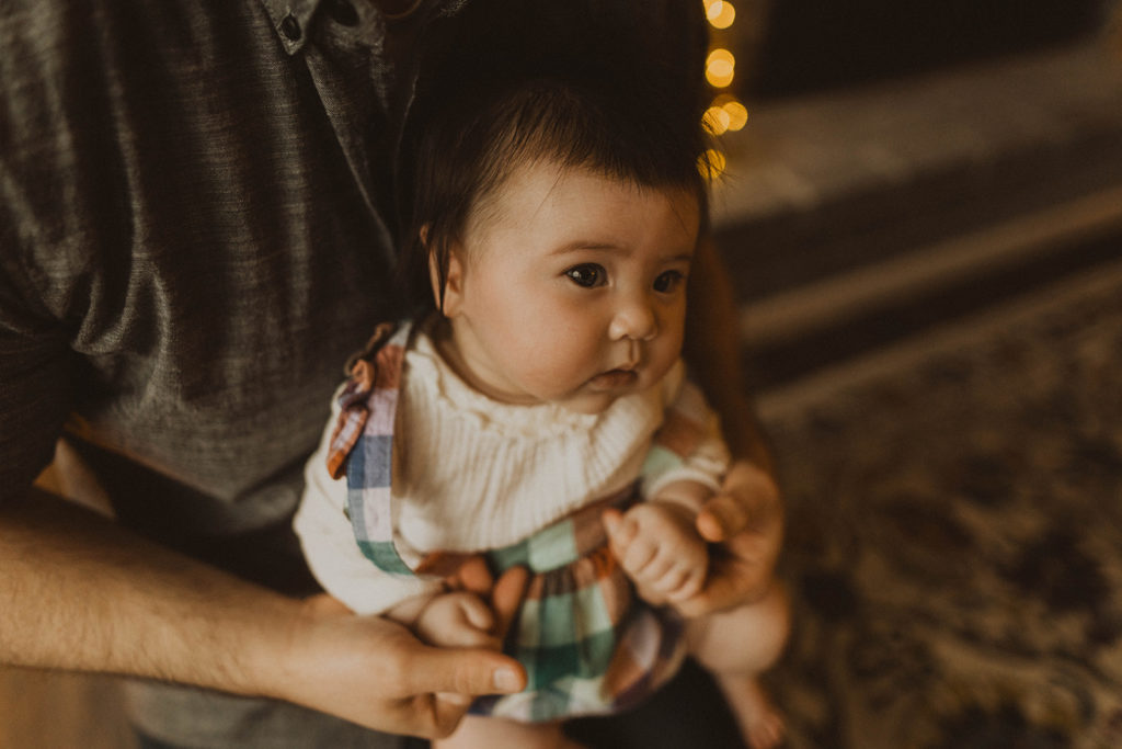 close up photo of the baby being held by her father during the Seattle family lifestyle session