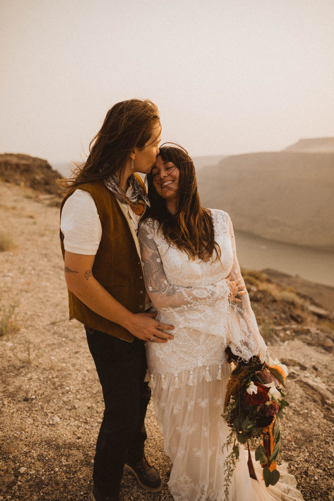 lgbtq brides smile together during their adventurous elopement in Idaho