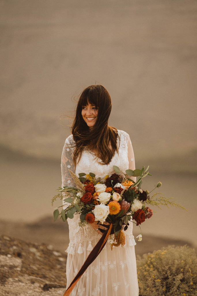 Bride holds her dream farm flowers wedding bouquet 
